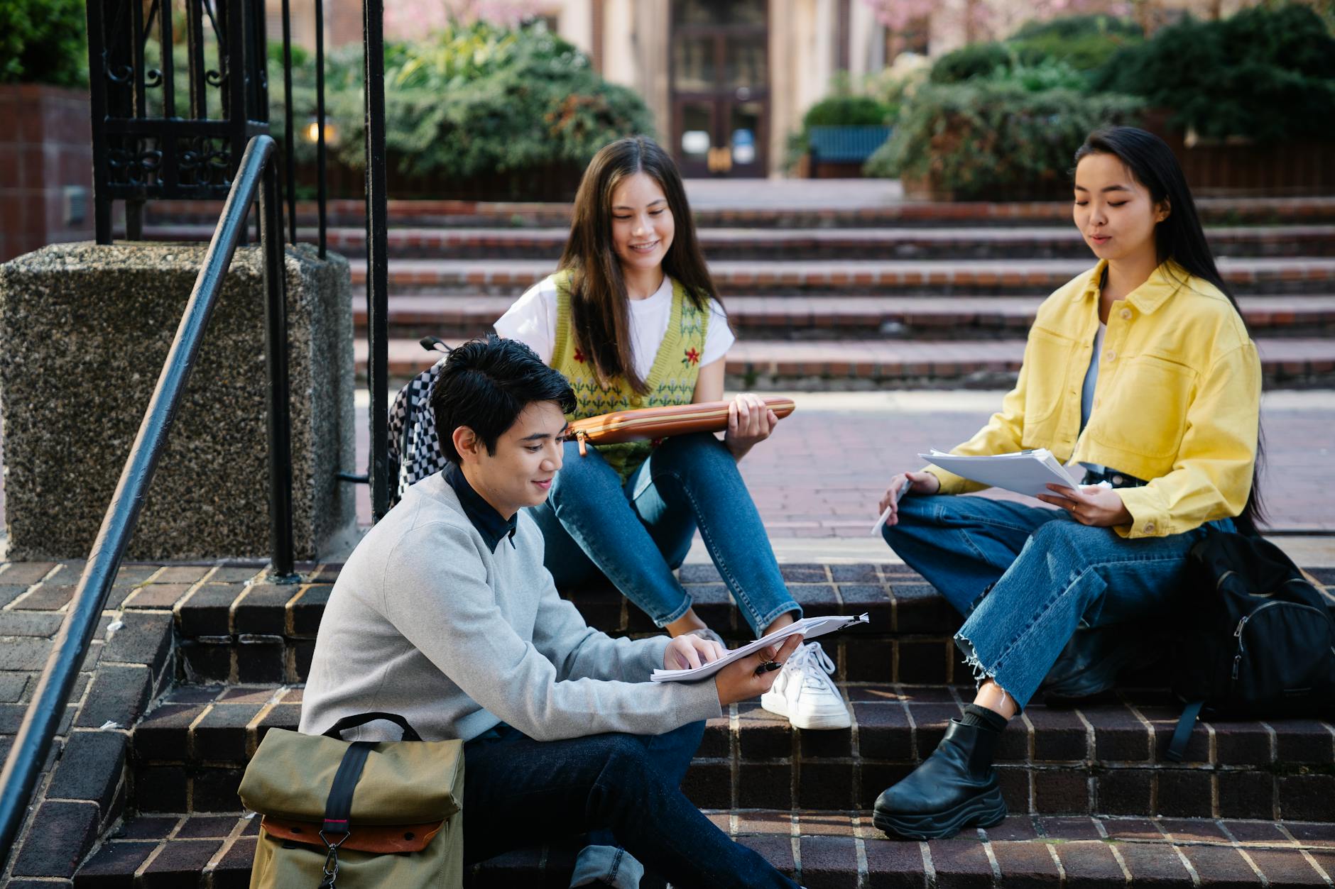 photograph of a group of friends sitting on brick steps