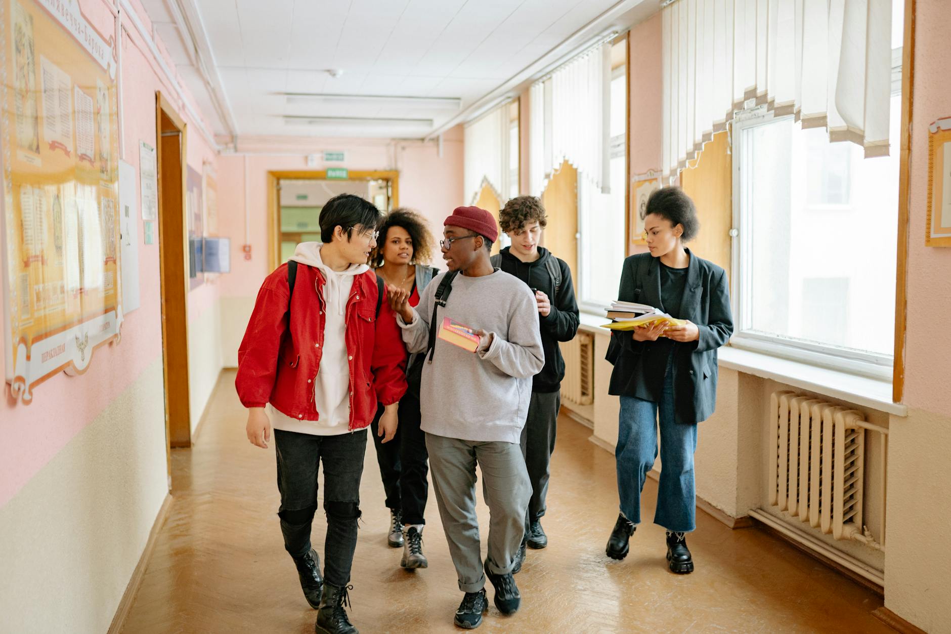 group of people walking on a hallway